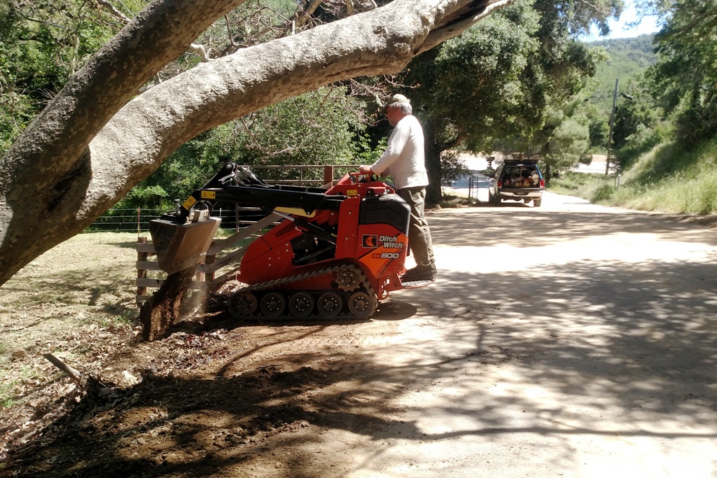 Joe removing mud from the trailhead emergency exit.